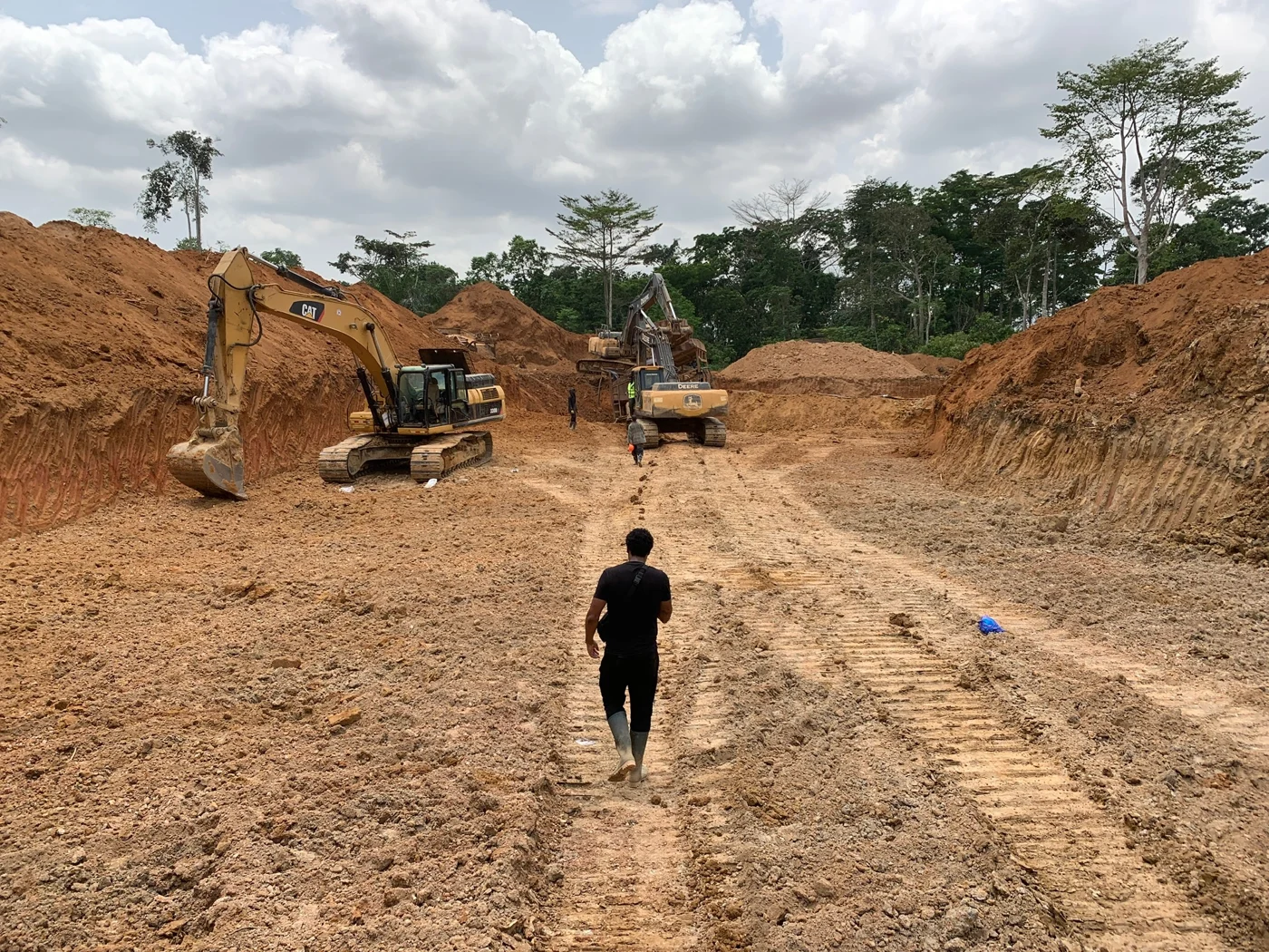 A worker walking across a mining site in Blockdor’s field archive